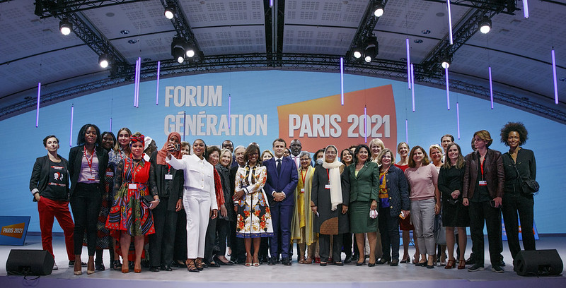 Crowd of participants on stage at the Generation Equality Forum in Paris against a background reading: Generation Equality Forum, Paris 2021